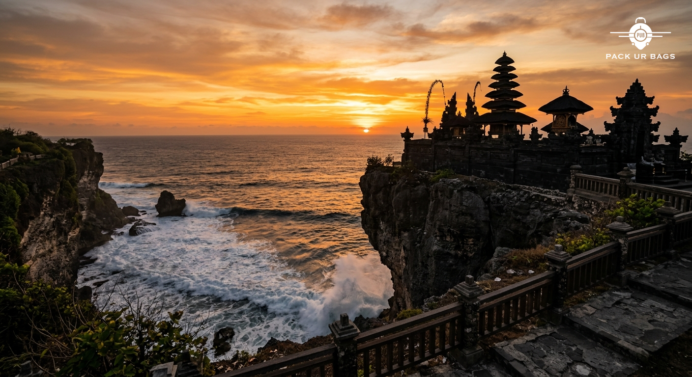 Sunset view from Uluwatu clifftop temple with dramatic ocean waves below and traditional Balinese temple silhouette agai