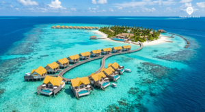 Aerial view of turquoise lagoon and overwater villas in Maldives, bright midday sun, vivid blues and whites, tropical re